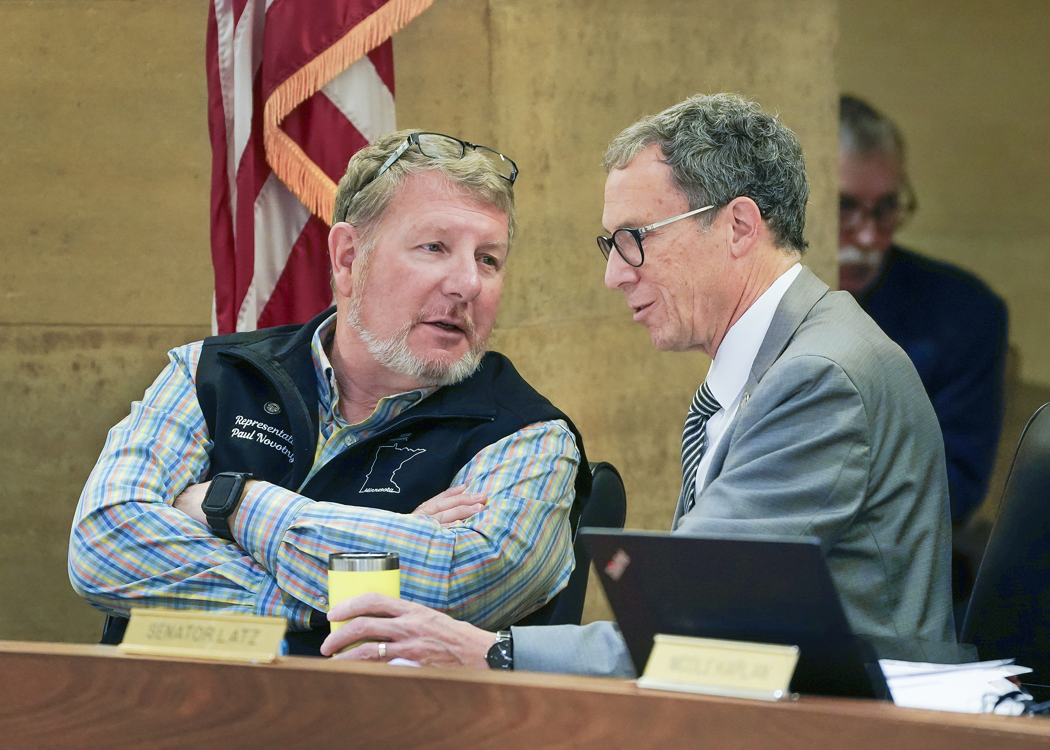 Rep. Paul Novotny and Sen. Ron Latz confer May 8 before the start of the conference committee on SF4760. (Photo by Andrew VonBank)